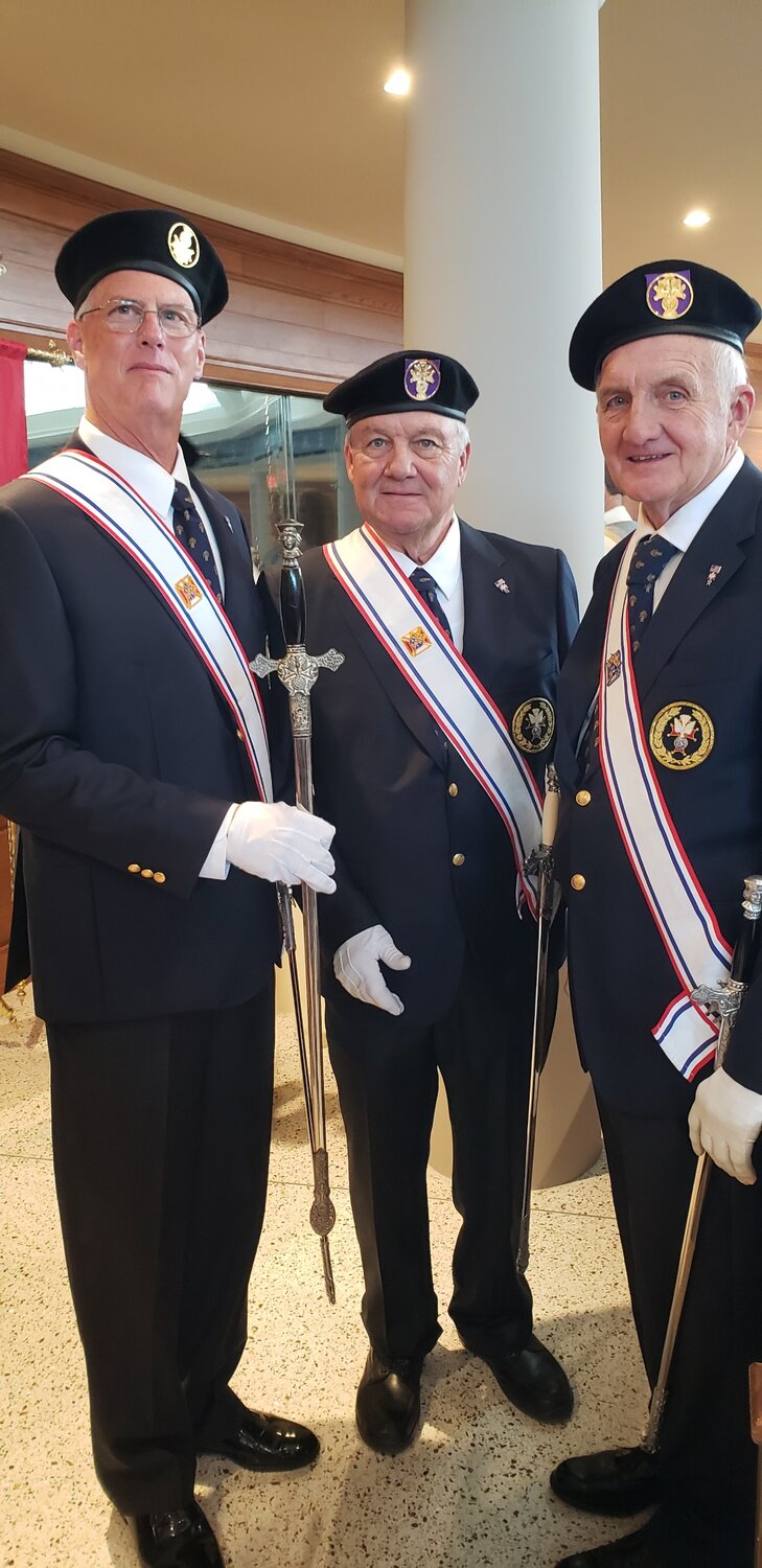 Members of the Knights of Columbus Fourth Degree honor guard display the sword that belonged to Fred Vogel, who was in the honor guard when the Cathedral was dedicated in 1974.